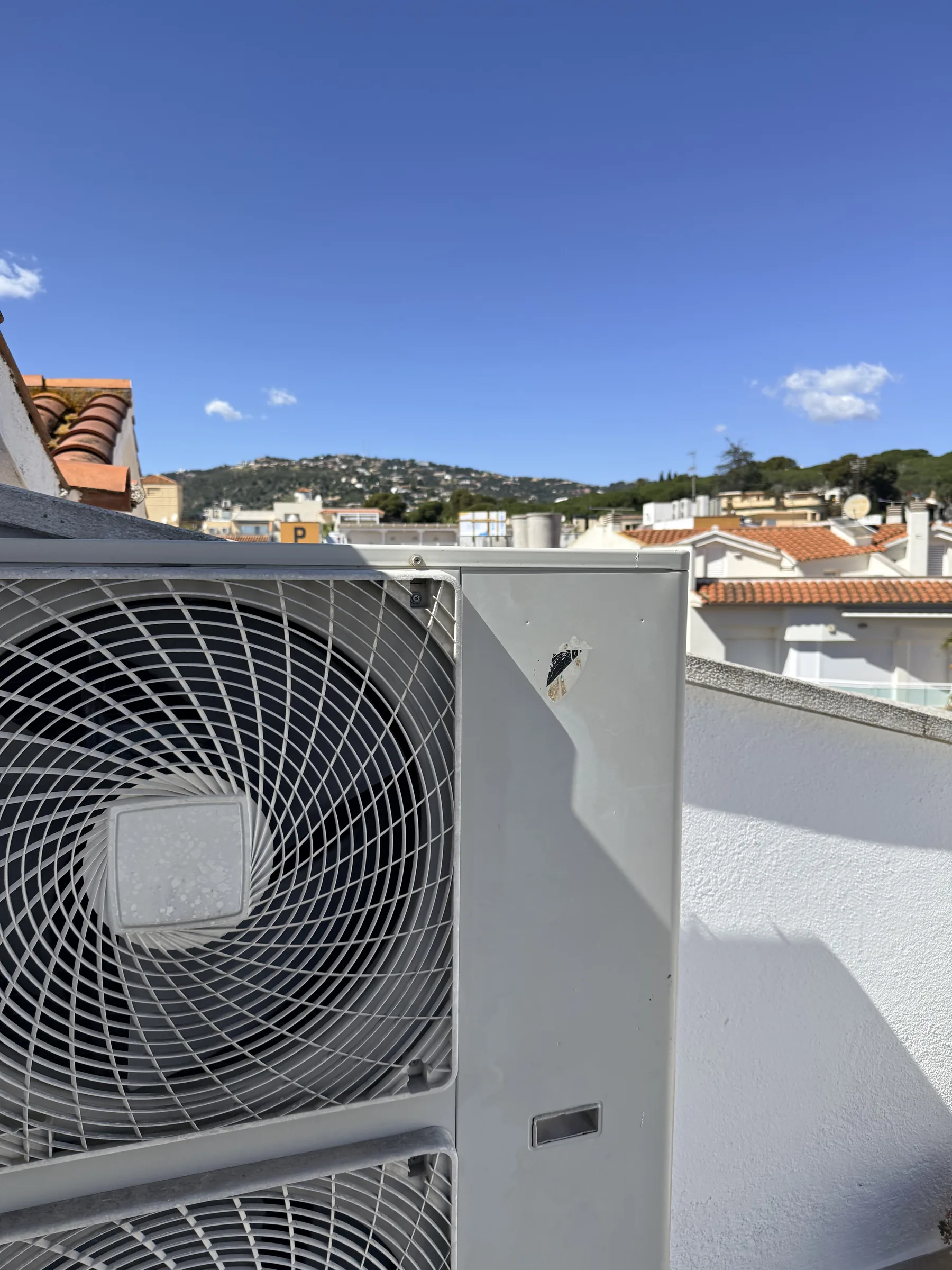 Unidad exterior de aire acondicionado en la terraza de la cubierta de un ático reformado en Platja d'Aro